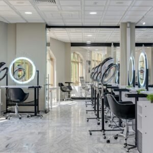 Bright and spacious hair salon interior featuring modern design elements and vanity mirrors.